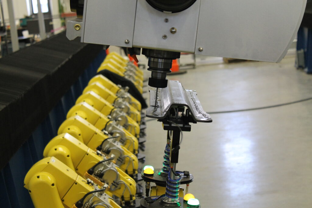 Robotic fixture holding carbon fiber part for drilling