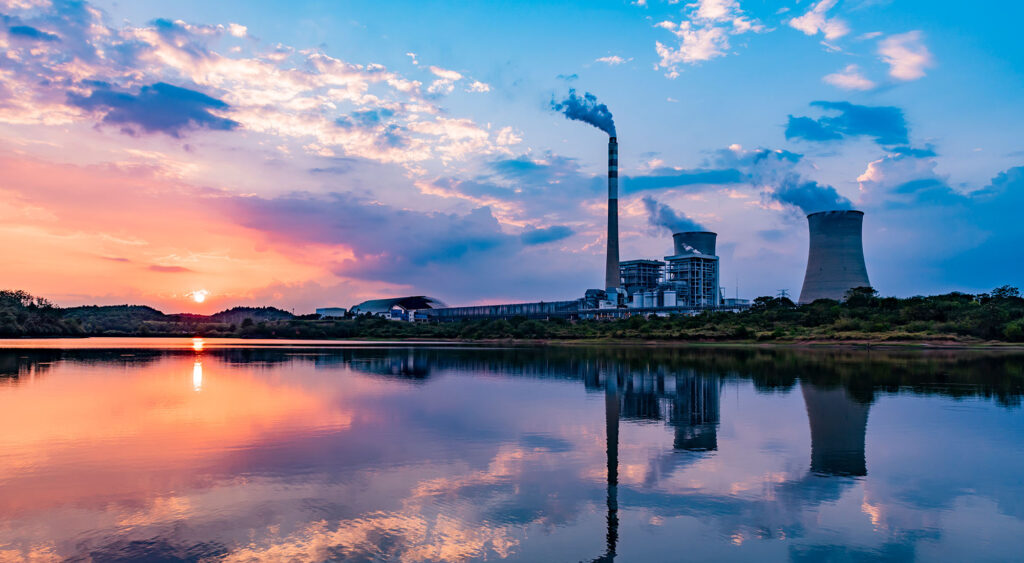 Long distance view of a nuclear power plant at sunset.