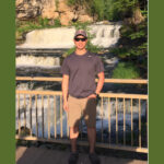Son Ngo, an engineer at PAR Systems standing in front of a waterfall
